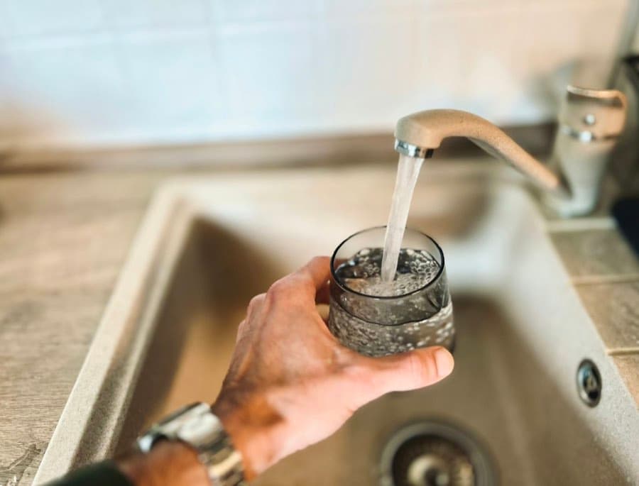 A glass filling with water at the kitchen tap
